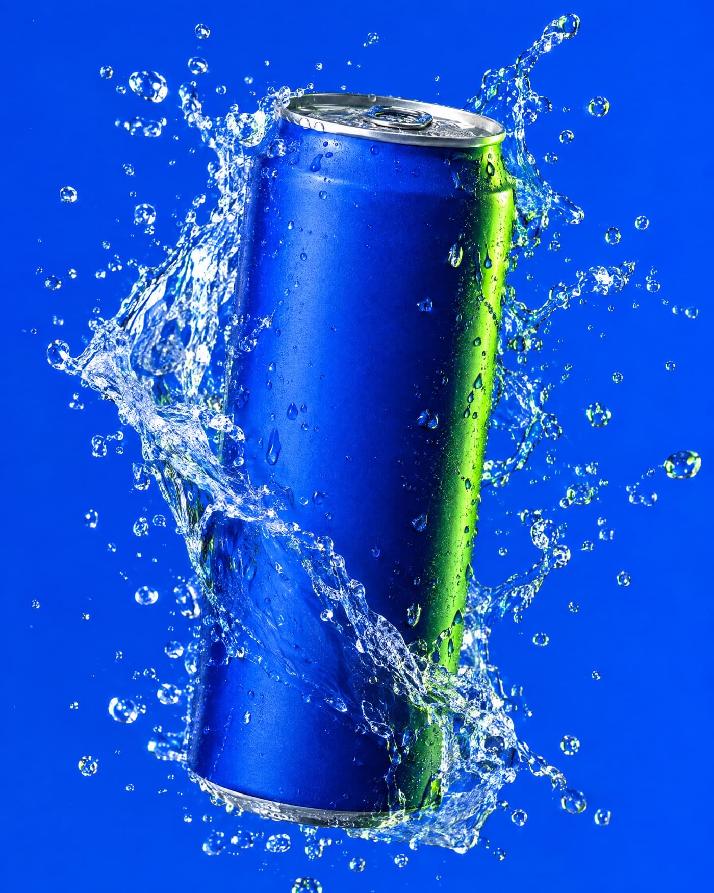 A plain matte blue drink can frozen inside a splash of water on an electric blue backdrop